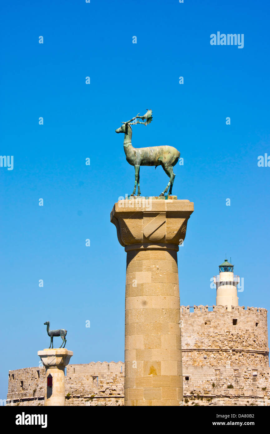 Symbolic deer statues and the Light House in Rhodes town's Mandraki Harbour Stock Photo Alamy