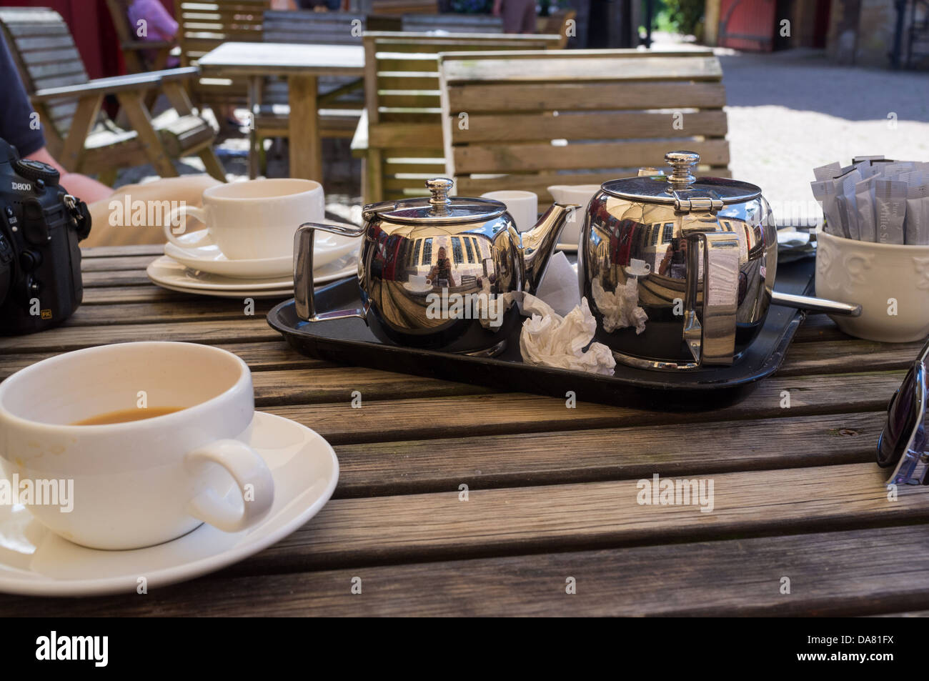 Bolham, Tiverton, Devon, UK. The remains of tea at the café in the stable block of Knightshayes Court. Stock Photo