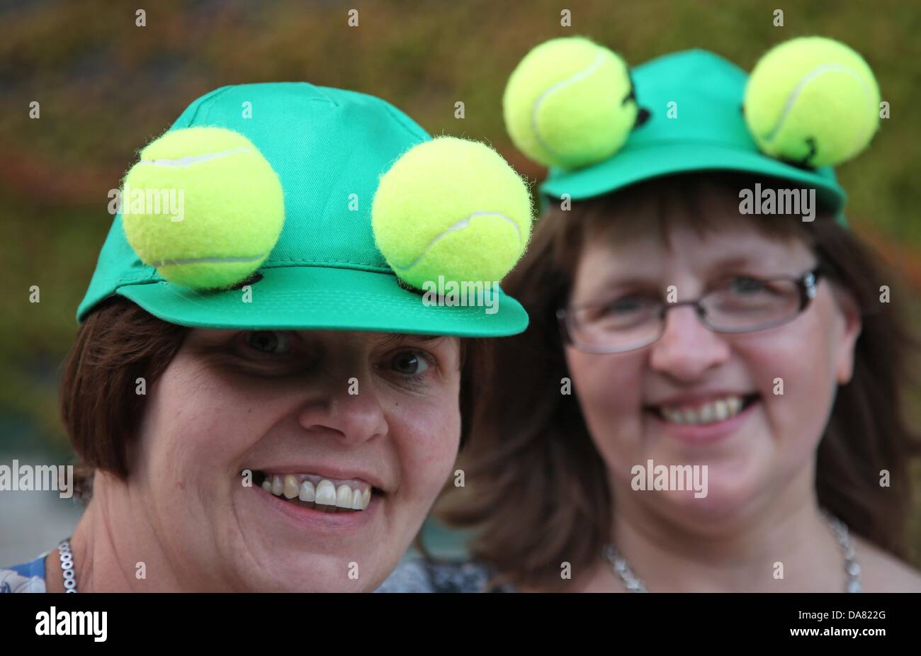 London, Britain. 06th July, 2013. Visitors wear hats with tennis balls