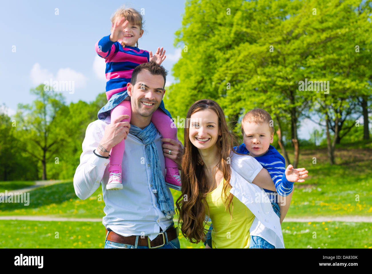 Father and daughter, he is carrying the girl on the shoulders and they do have lots of fun Stock Photo