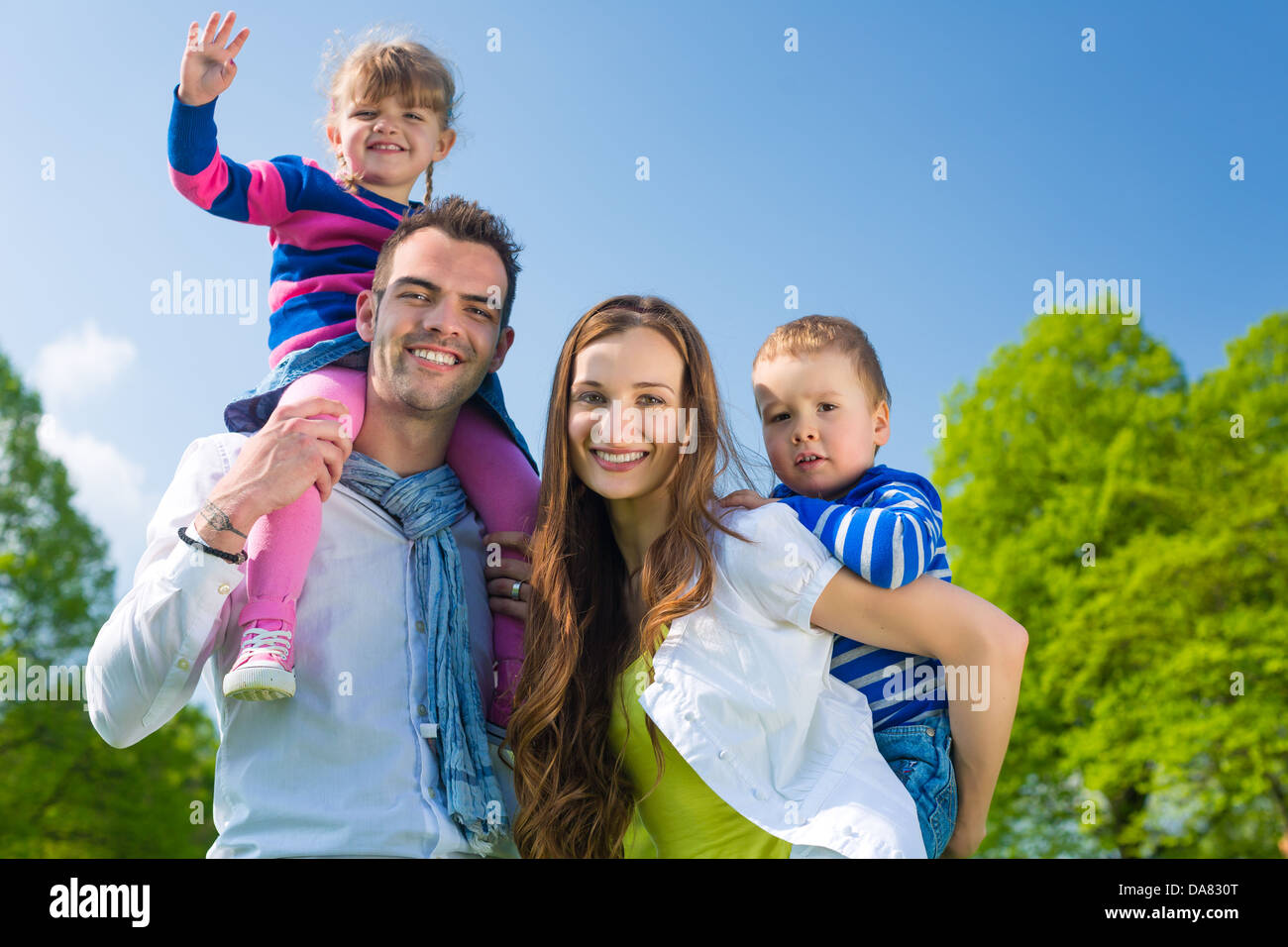 Father and daughter, he is carrying the girl on the shoulders and they do have lots of fun Stock Photo