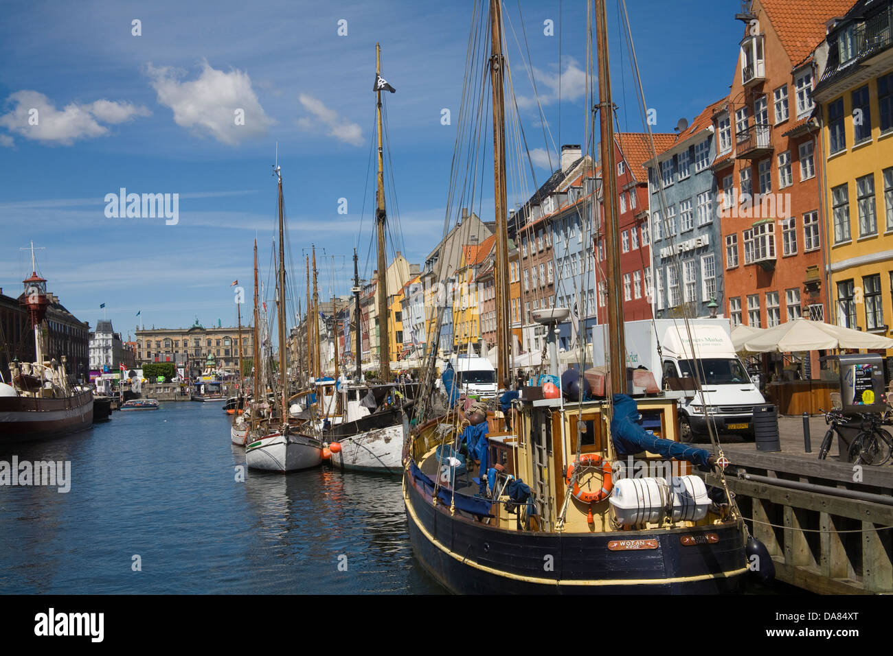 Copenhagen Denmark EU View along Nyhavn canal with moored sailing boats and colourful facades of 17thc buildings Stock Photo