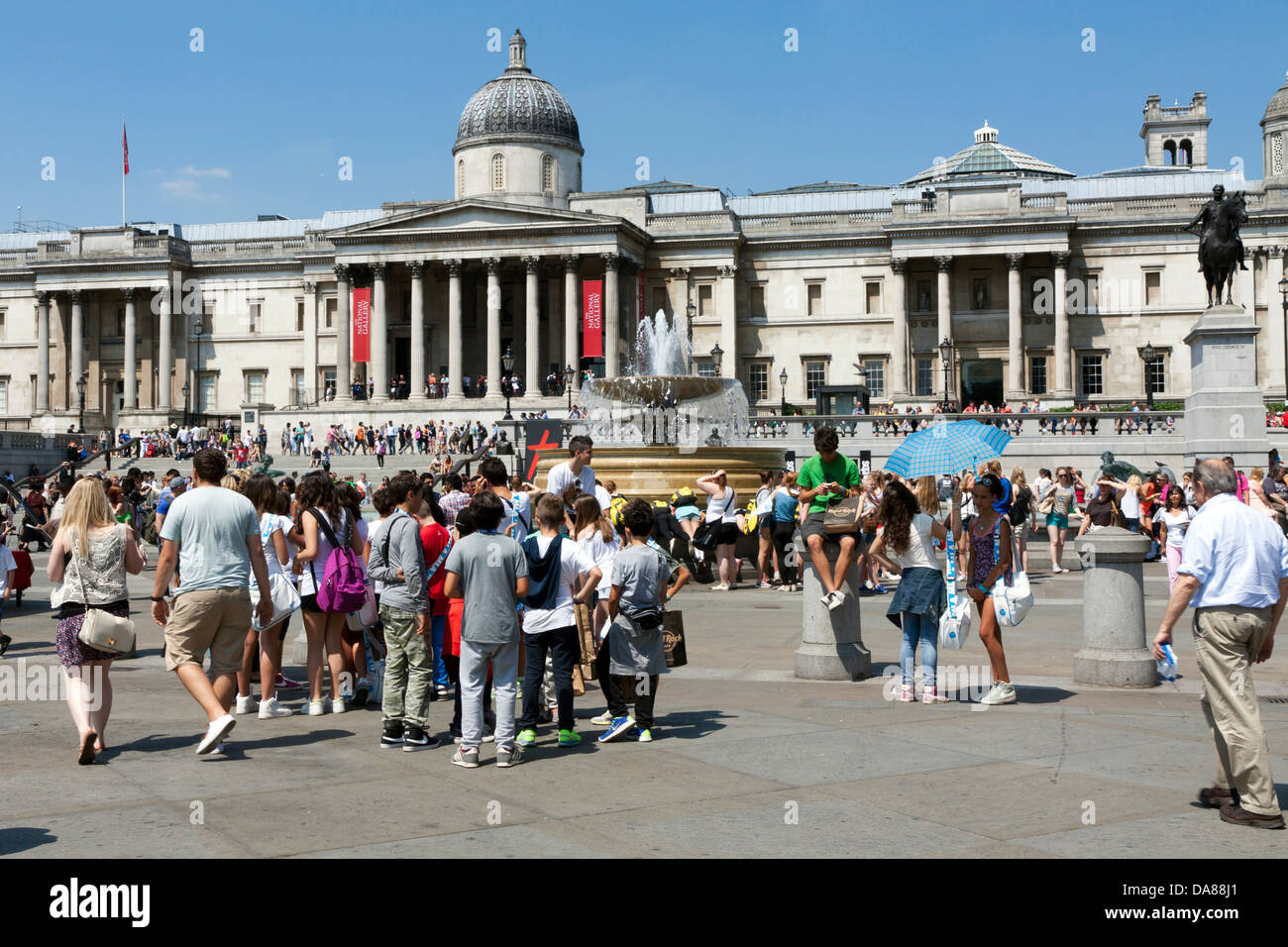 Visitors enjoying London's Trafalgar Square in summertime Stock Photo