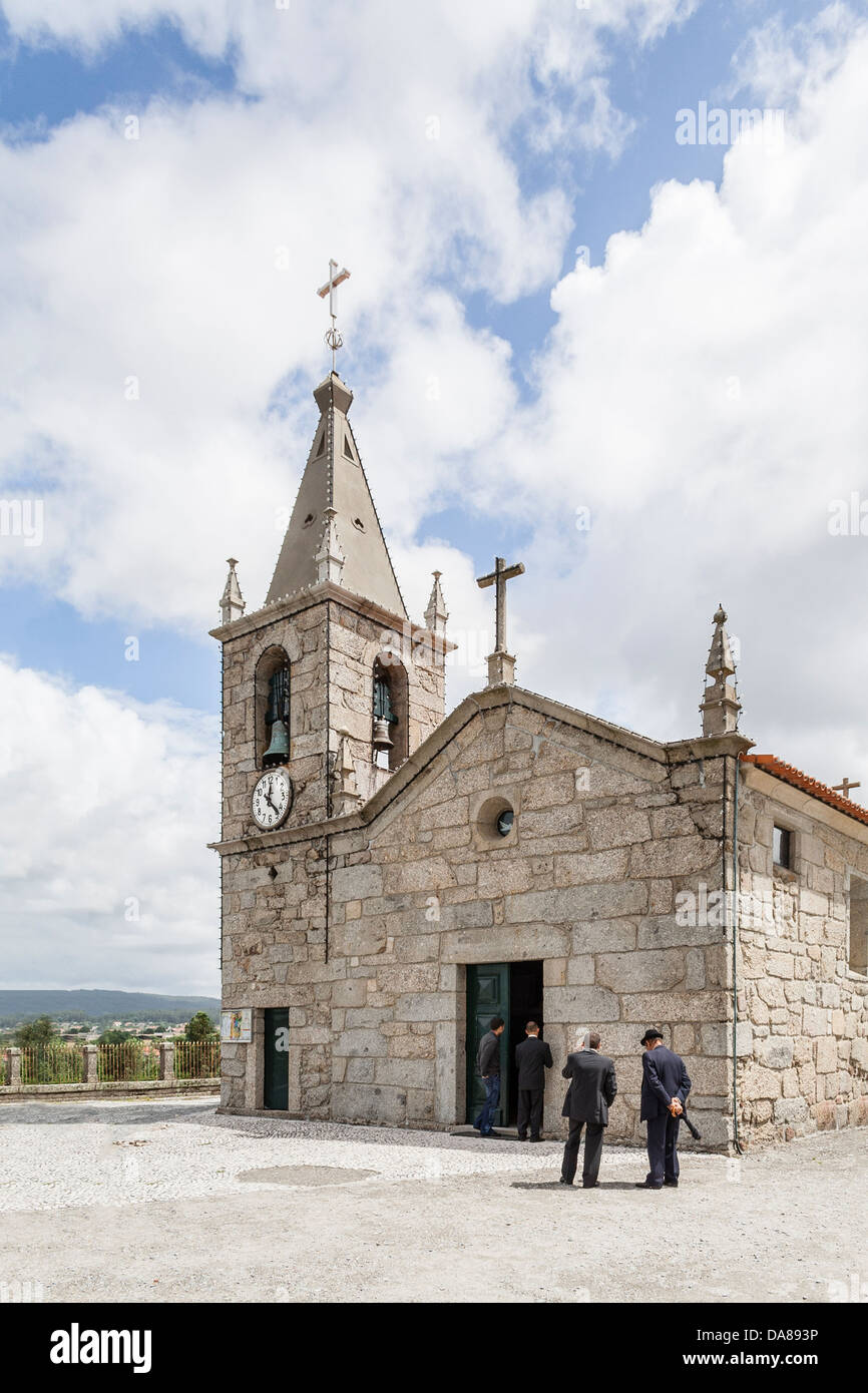 Typical small parish church during mass with men waiting outside. Avidos, Vila Nova de Famalicão, Braga, Minho, Portugal Stock Photo