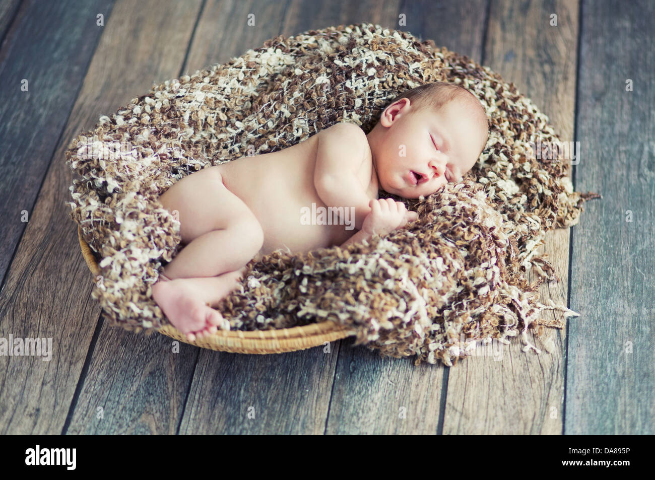 Newborn cute baby sleeping in wicker basket Stock Photo Alamy