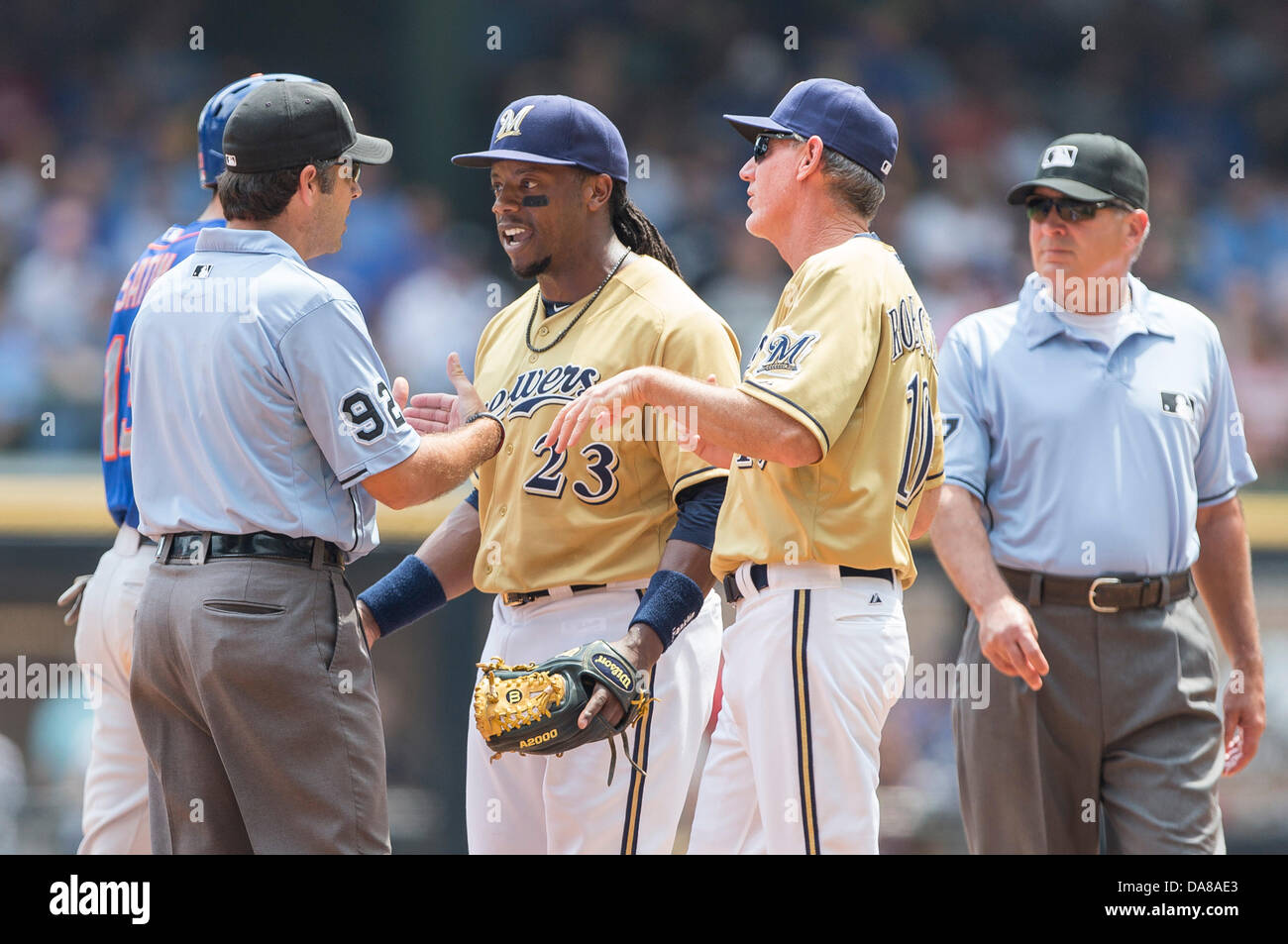 July 7, 2013 - Milwaukee, Wisconsin, United States of America - July 7, 2013: Milwaukee Brewers second baseman Rickie Weeks #23 along with Milwaukee Brewers manager Ron Roenicke #10 discusses the call with umpire John Hirschbeck during the Major League Baseball game between the Milwaukee Brewers and the New York Mets at Miller Park in Milwaukee, WI. Mets lead the Brewers 2-1 in the 8th inning. John Fisher/CSM. Stock Photo