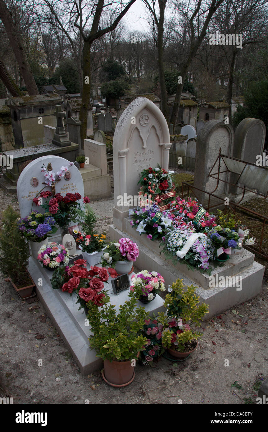 Parisian Graveyard. Fresh wreaths of flowers laid on two graves in the Père Lachaise cemetery