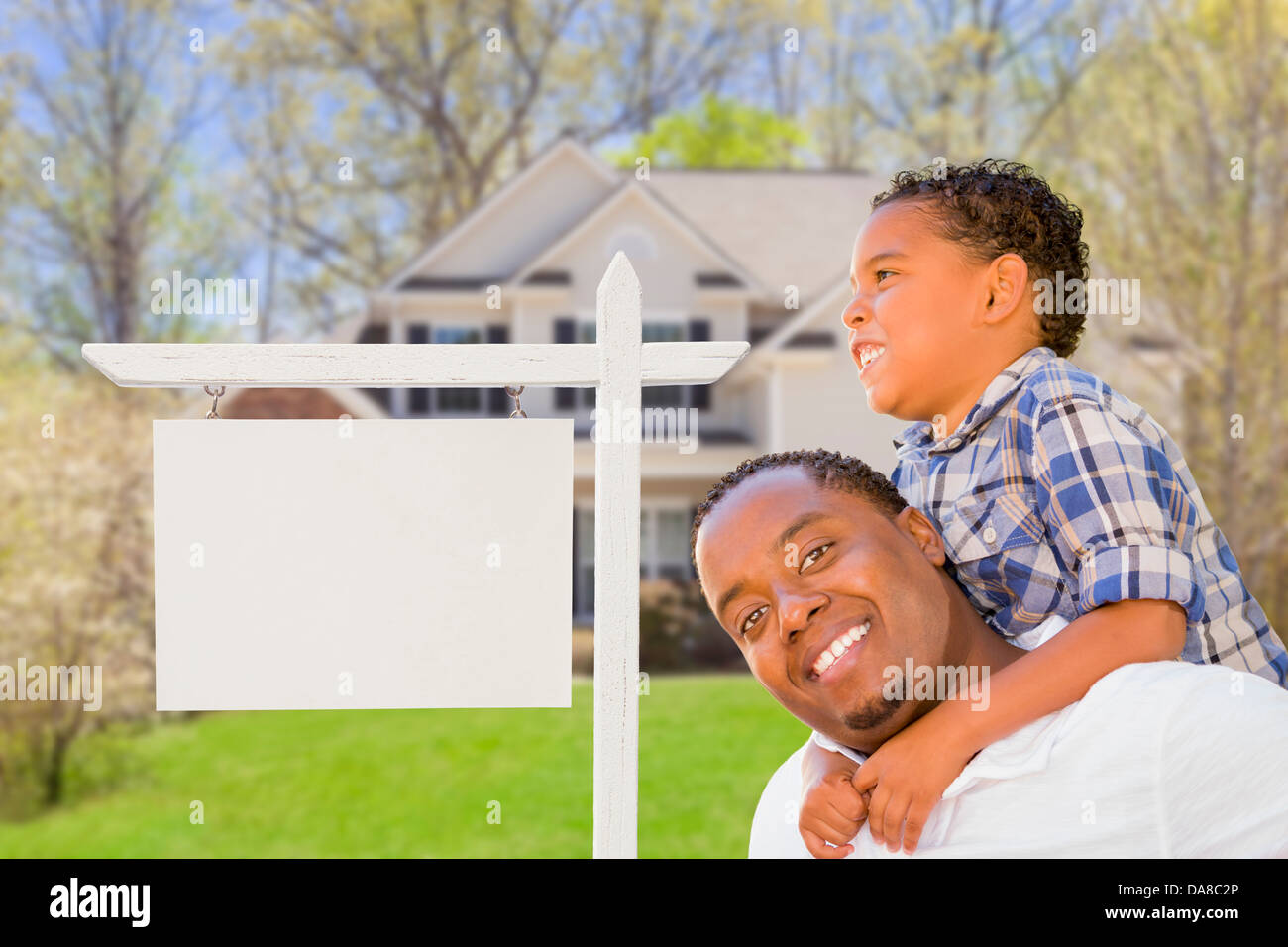 Happy African American Father and Mixed Race Son In Front of Blank Real ...