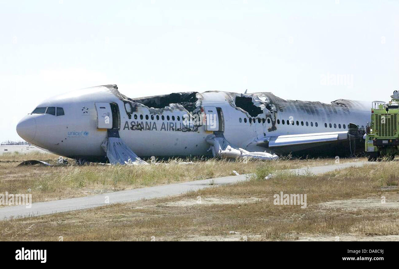 Remains of the Asiana Flight 214 Boeing 777 rests near the runway of San Francisco International July 7, 2013 in San Francisco. Stock Photo