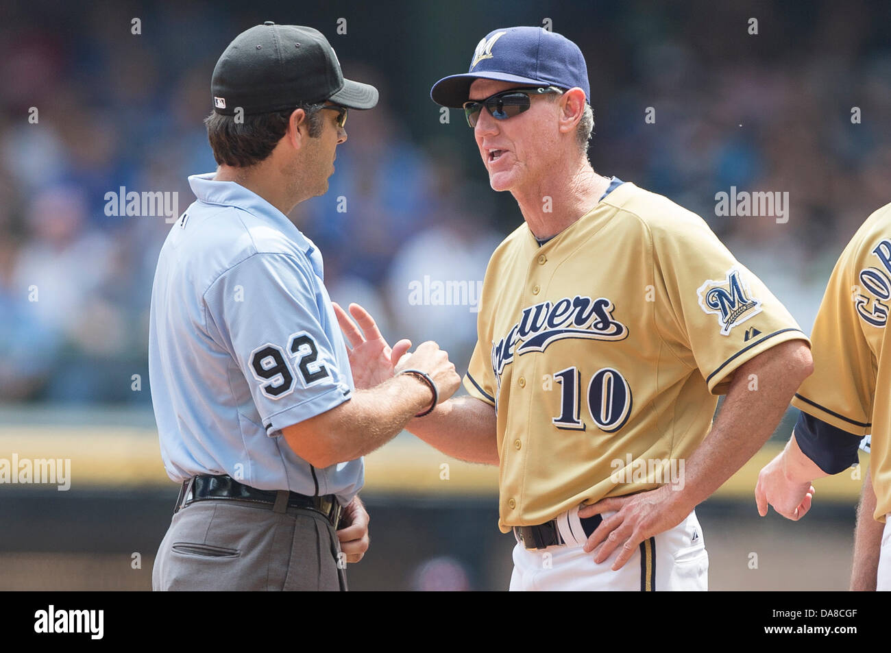 Milwaukee, Wisconsin, USA. 7th July, 2013. July 7, 2013: Milwaukee Brewers manager Ron Roenicke #10 discusses a call with umpire John Hirscbeck during the Major League Baseball game between the Milwaukee Brewers and the New York Mets at Miller Park in Milwaukee, WI. Mets win 2-1. John Fisher/CSM. Credit:  csm/Alamy Live News Stock Photo