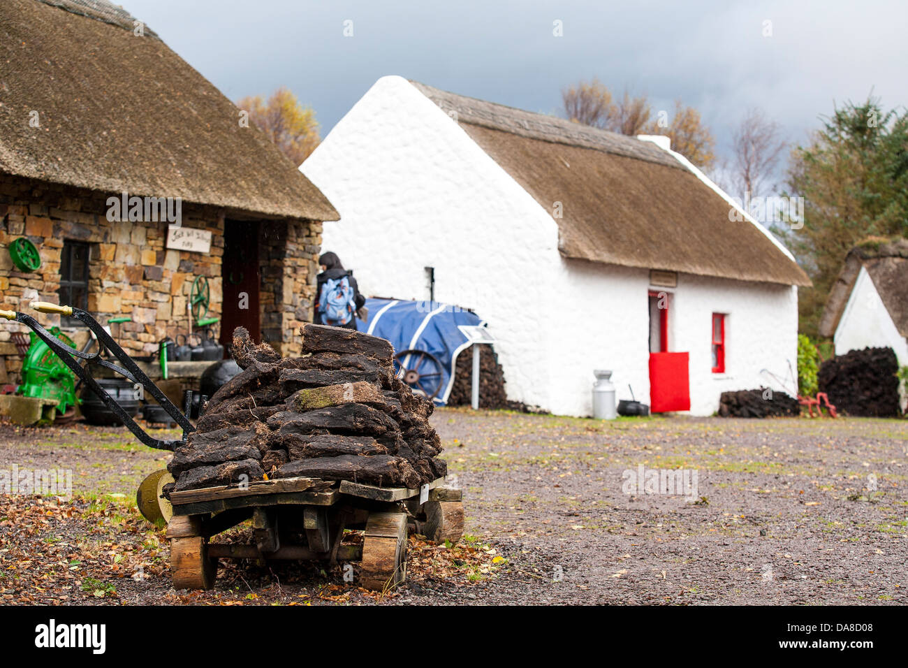 A pile of cut peat in front of cottages of the Kerry Bog Village in Co