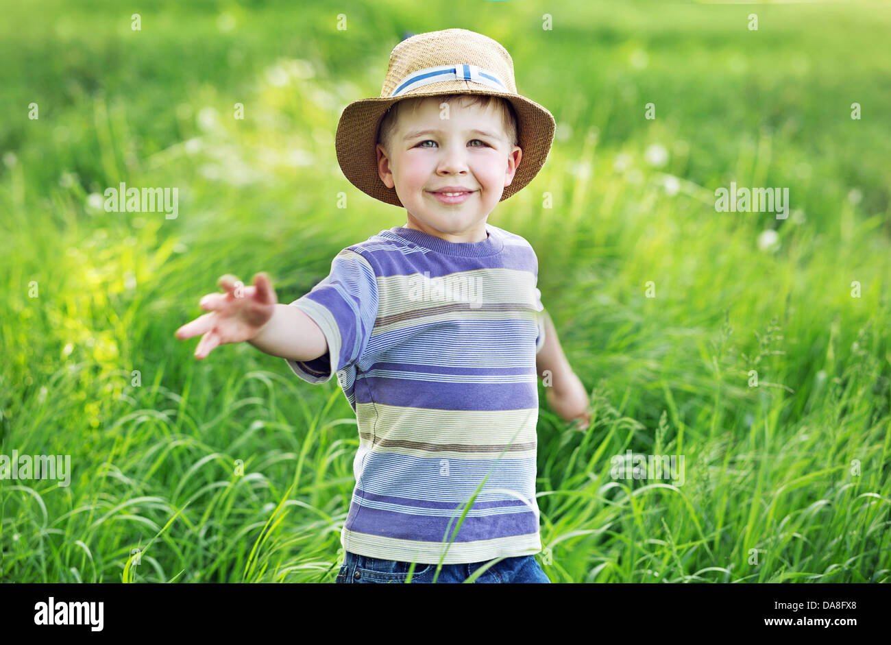 Portrait of a cute small kid playing on the meadow Stock Photo Alamy
