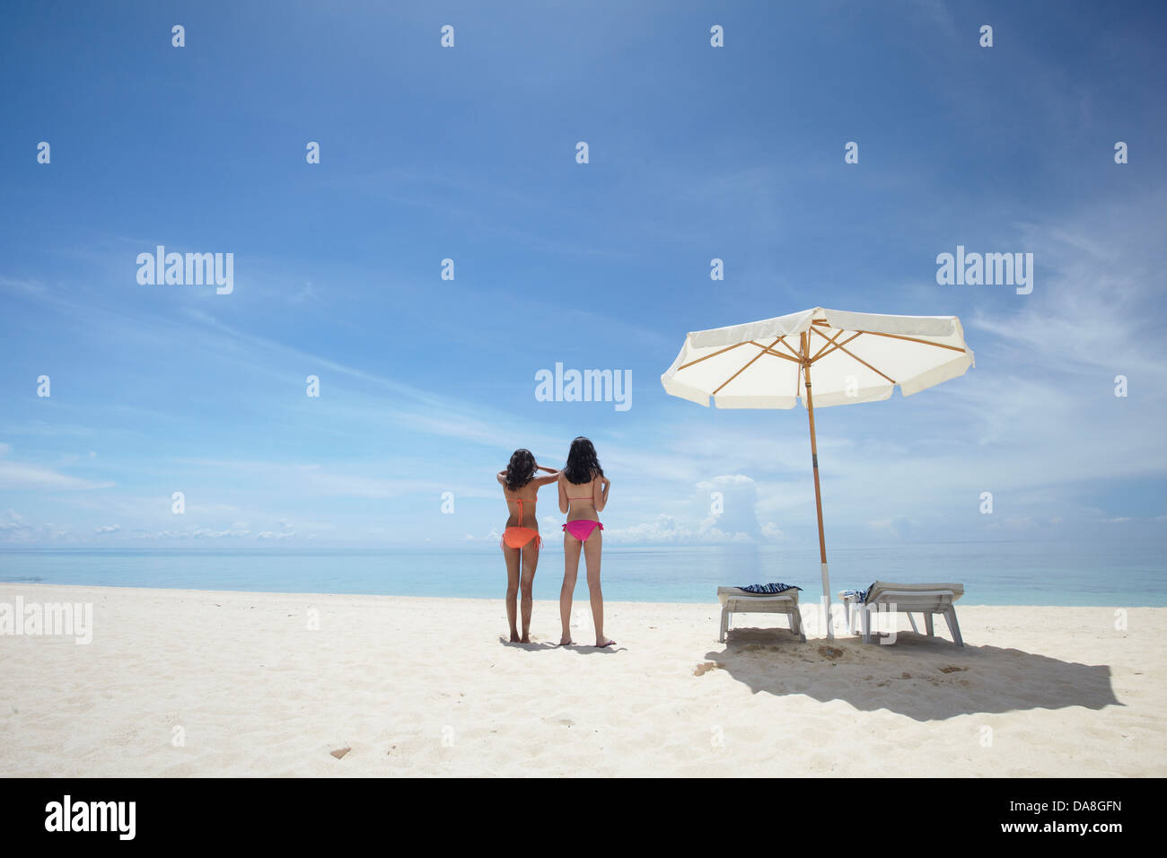 Friends relaxing on a beach. Stock Photo