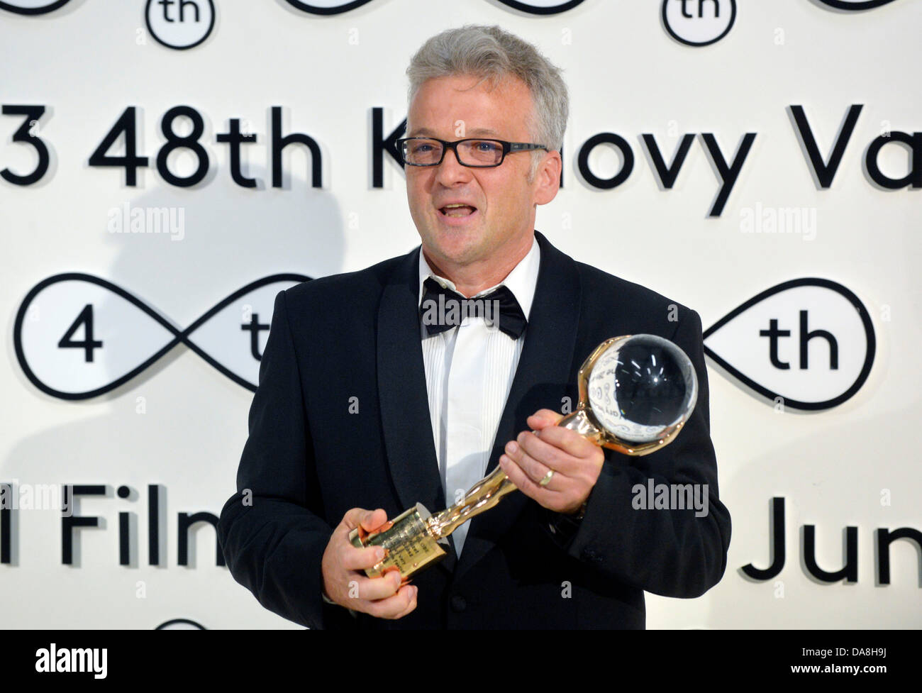 Karlovy Vary, Czech Republic. 6th July, 2013. Producer Sandor Soth took over the Crystal Globe award for the best feature for Janos Szasz's movie Le grand cahier at the closing ceremony of the 48th Karlovy Vary International Film Festival in Karlovy Vary, Czech Republic, on Sunday, July 6, 2013. The winning film, Le grand cahier, shot in coproduction with Germany, Austria and France, is an adaptation of the first novel by Hungarian writer Agota Kristof, telling a story of 13-year-old twins forced to spend the last years of WWII with their cruel grandmother somewhere near the Hungarian border.  Stock Photo