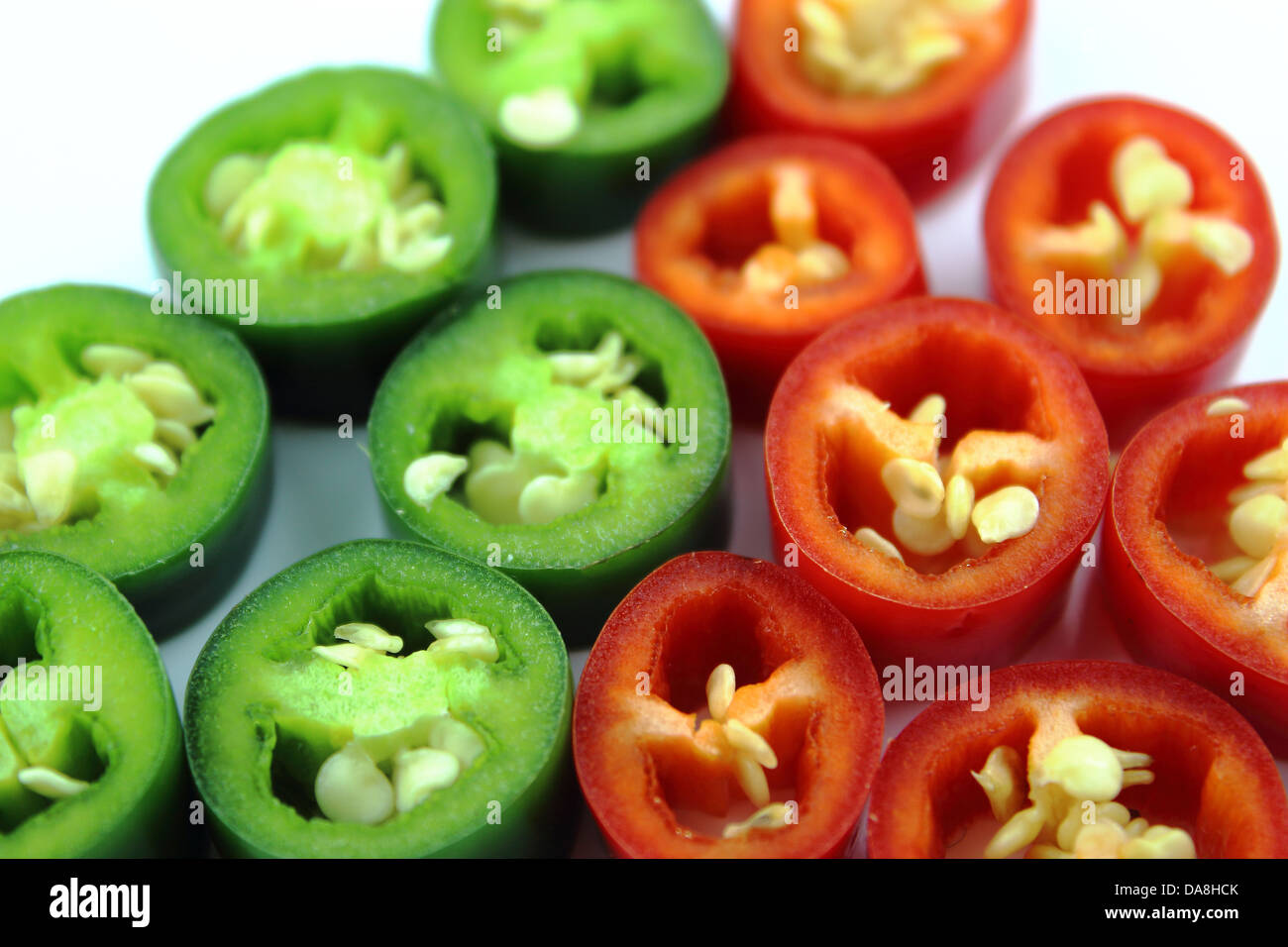 red and green hot chili pepper slices on a white background Stock Photo ...