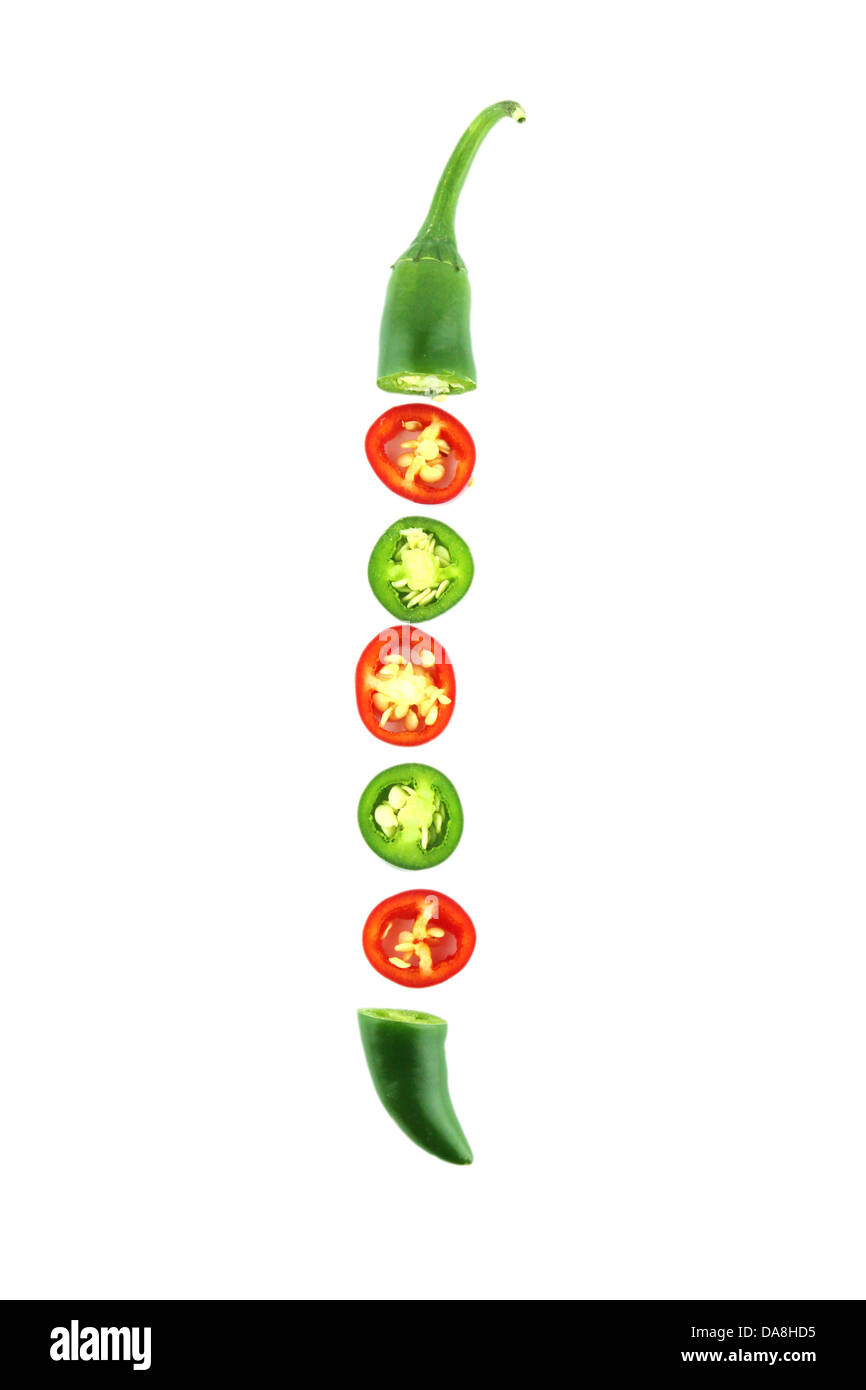 red and green hot chili pepper slices on a white background with a ...