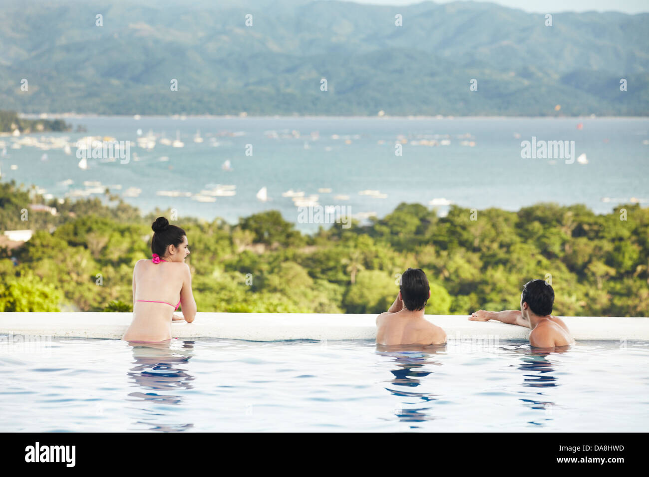 Friends relaxing poolside. Stock Photo