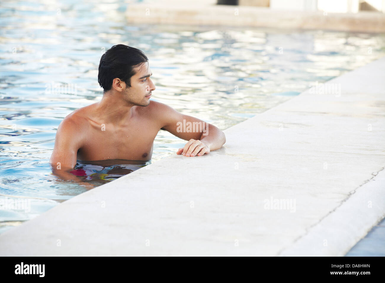 A man relaxing poolside. Stock Photo