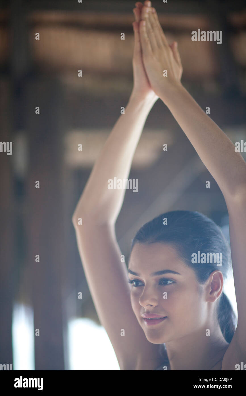 Woman practicing yoga arms outstretched hi-res stock photography and ...