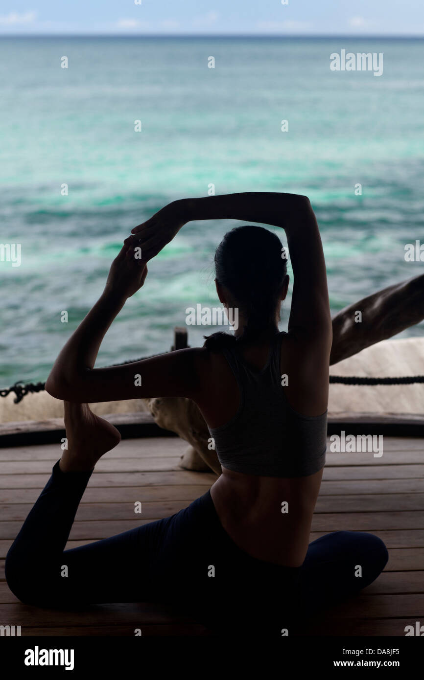 A young woman practicing yoga Stock Photo - Alamy