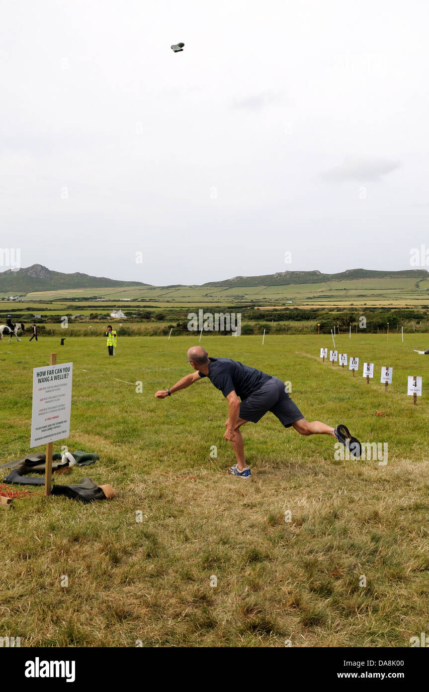 man throwing a wellington in a wang a wellie competition Pembrokeshire Wales Cymru UK GB Stock Photo