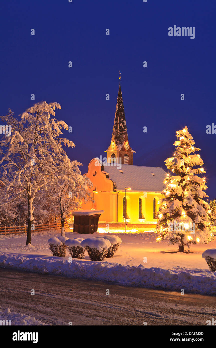 Austria, Europe, Tyrol, Mieminger plateau, Obsteig, Christmas, Christmas tree, Advent, church, lights, snow, winter, evening, mo Stock Photo
