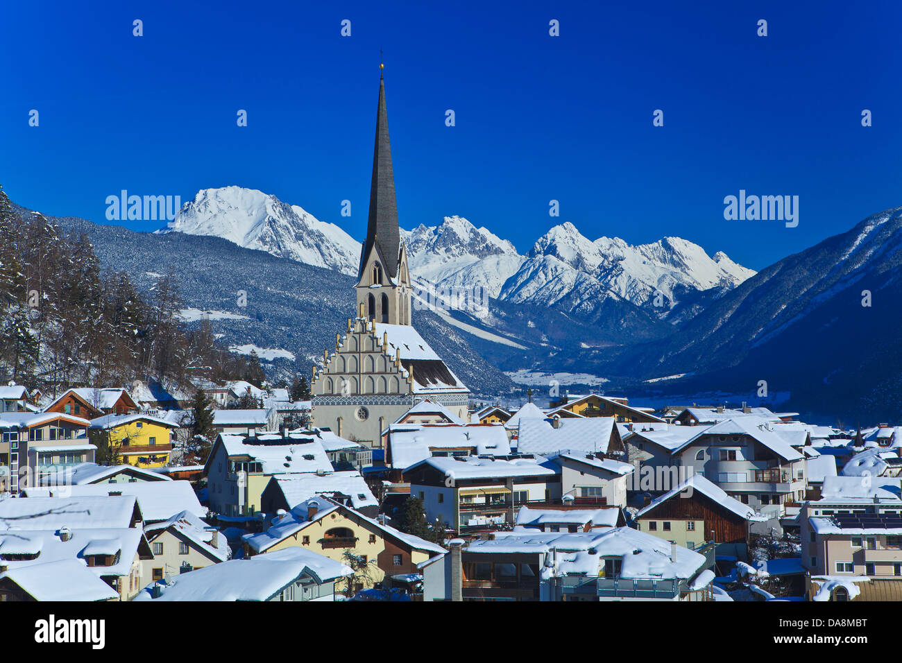 Austria, Europe, Tyrol, Oberinntal, Imst, district capital, winter, mountains, Mieminger chain, wood, forest, houses, homes, chu Stock Photo