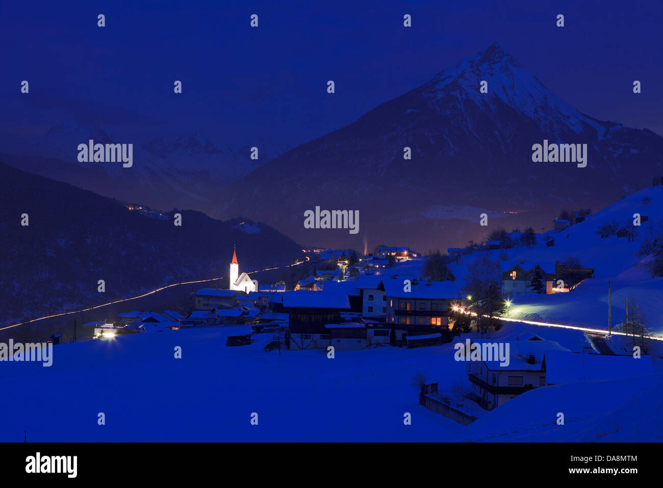 Austria, Europe, Tyrol, uplands, Imst, mountain Imster, winter, evening, dusk, twilight, night, place, lights, church, mountains Stock Photo