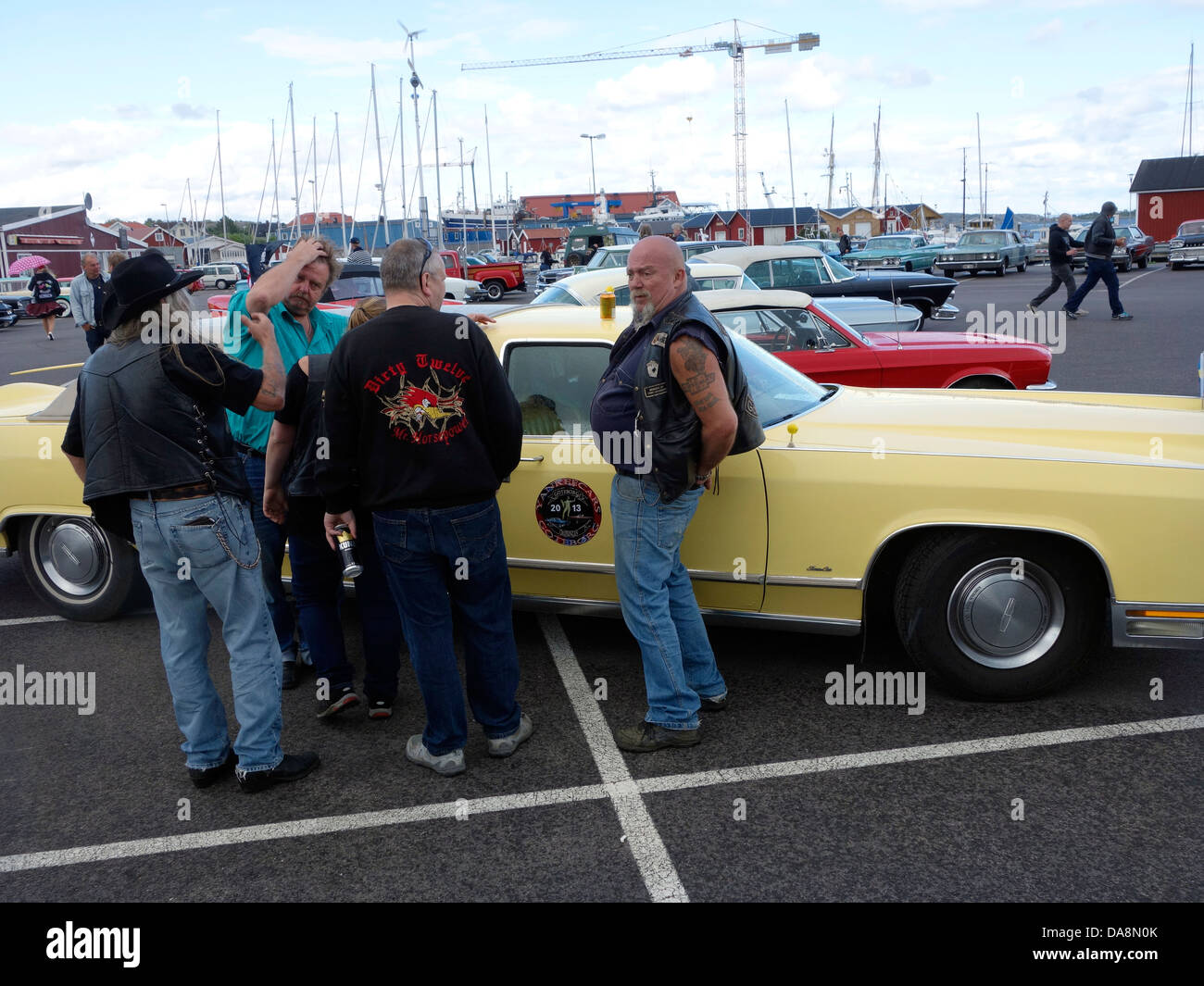 “Raggare” Rockabilly style middle aged men stand next to the Lincoln Town Car – 78 Stock Photo