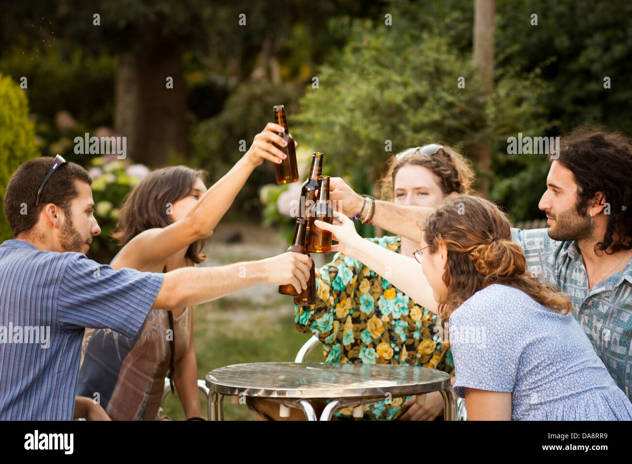 Group of friends making a toast with beer in a terrace outdoors Stock Photo