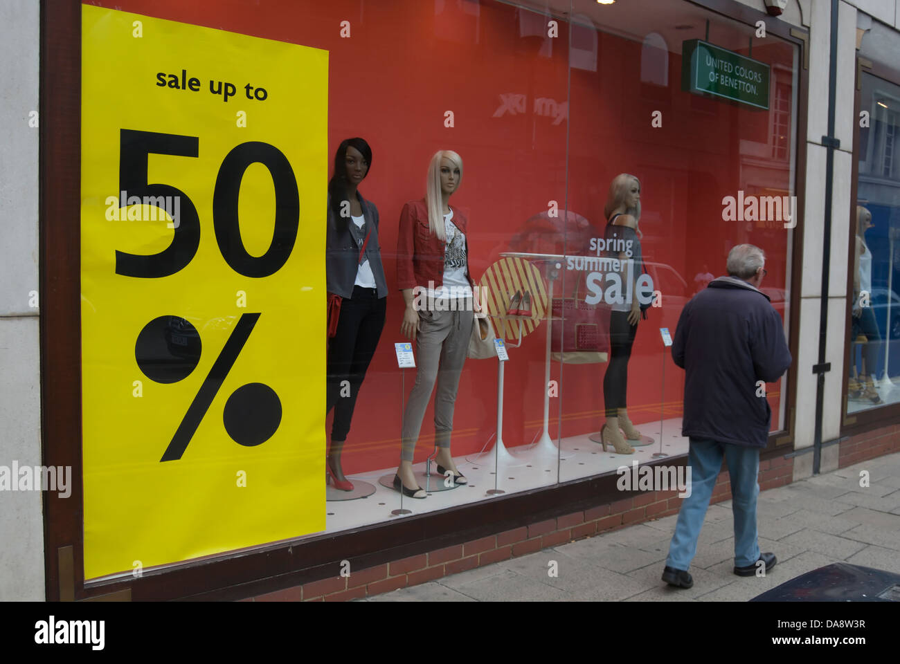 united colours of benetton shop window display advertising a sale with up  to 50% off, as man passes by Stock Photo - Alamy
