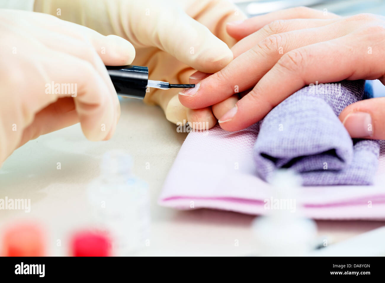 Nail treatment at nail salon, Nail polish, or nail varnish to fingernails to decorate and protect Stock Photo