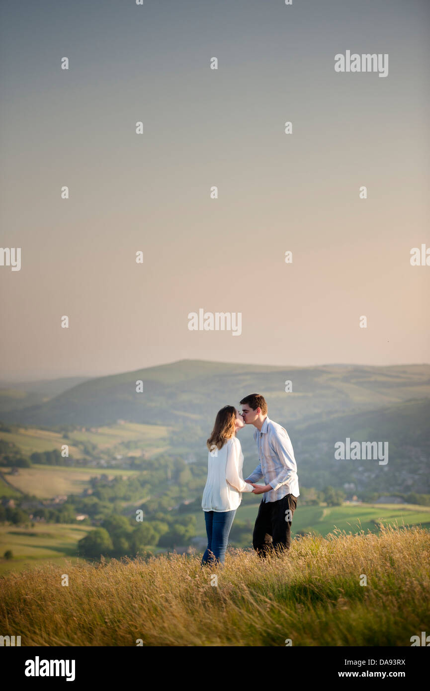 young couple kissing on a hill Stock Photo