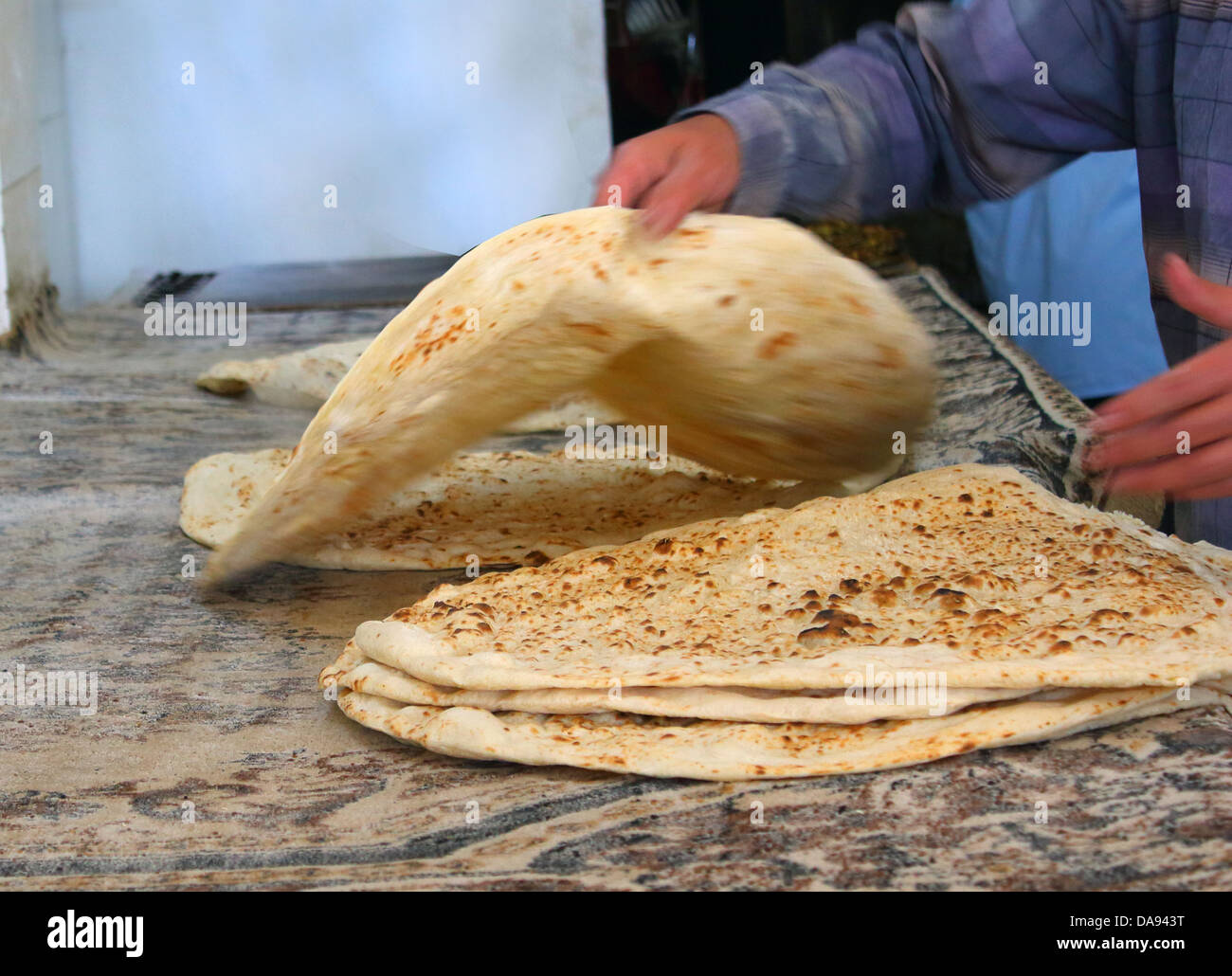 arab baker making arabic bread . Stock Photo