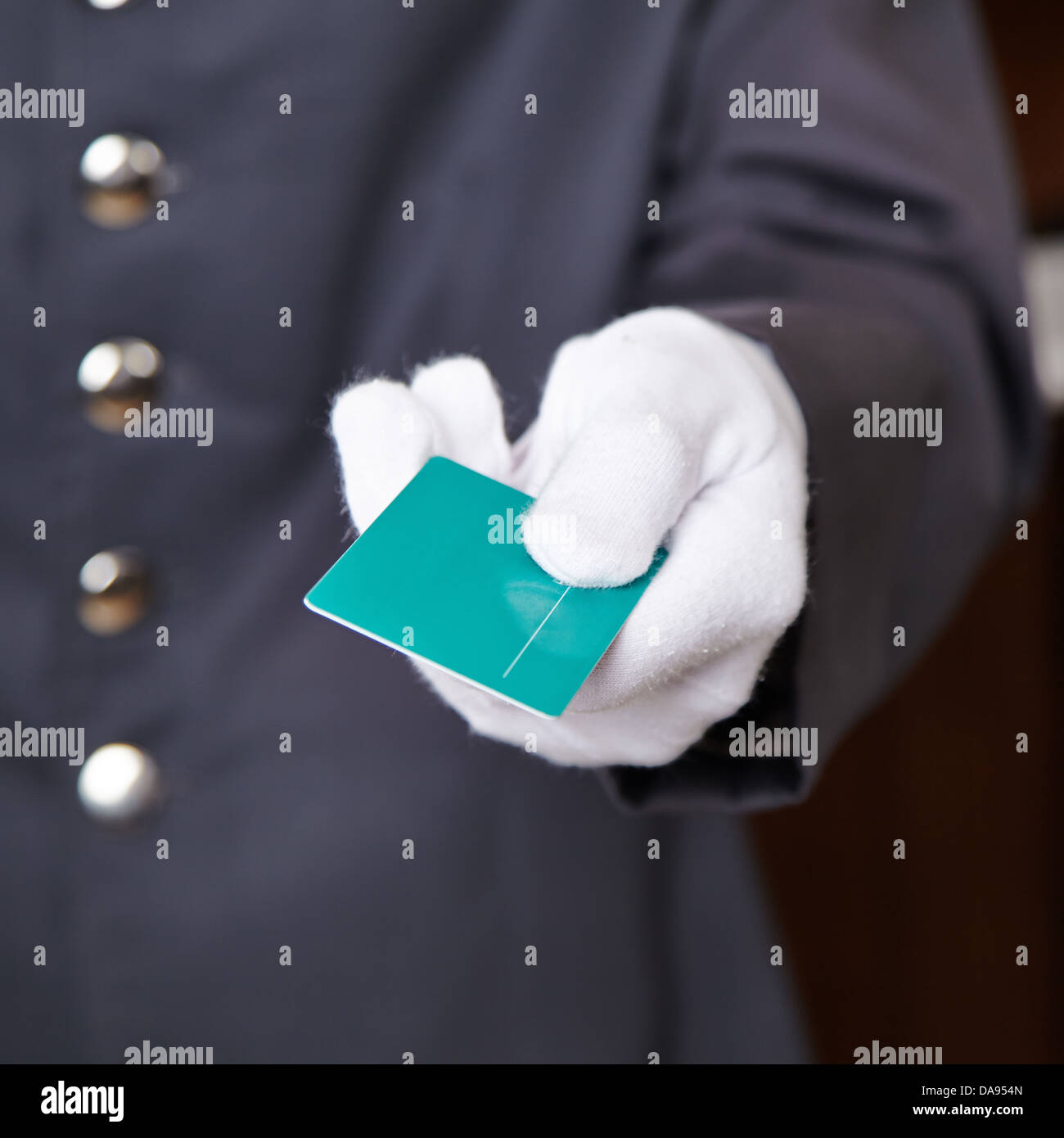 Hand of doorman giving key card to hotel room Stock Photo