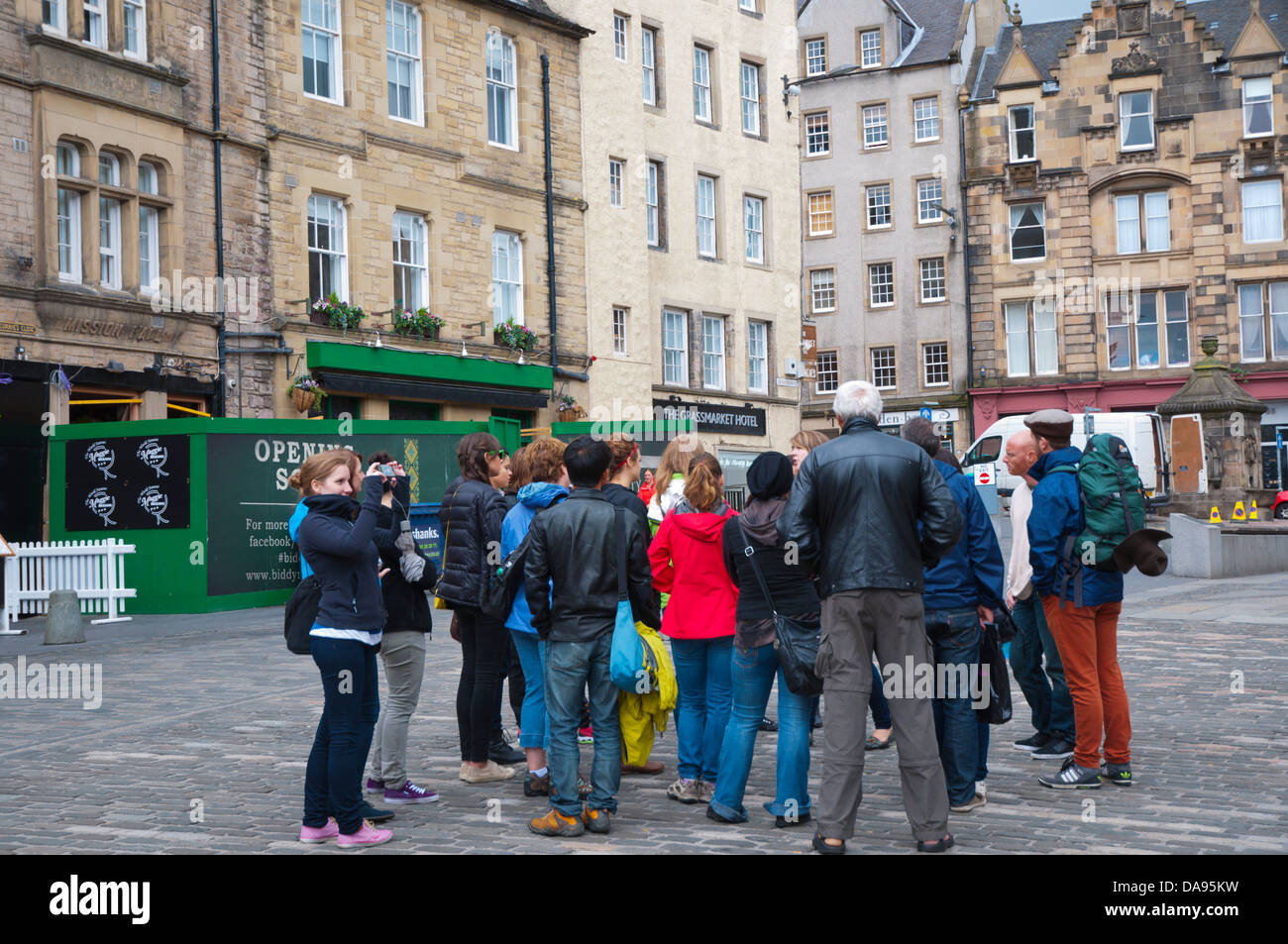 Tourist group with a tour guide Grassmarket old town Edinburgh Scotland Britain UK Europe Stock