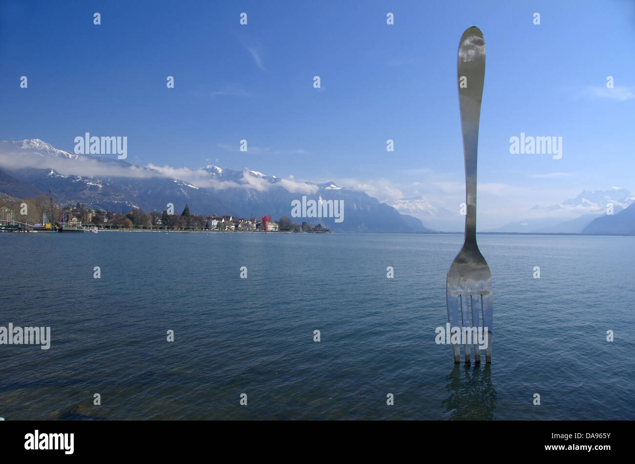 Giant fork sculpture inserted into lake Geneva Switzerland. In the