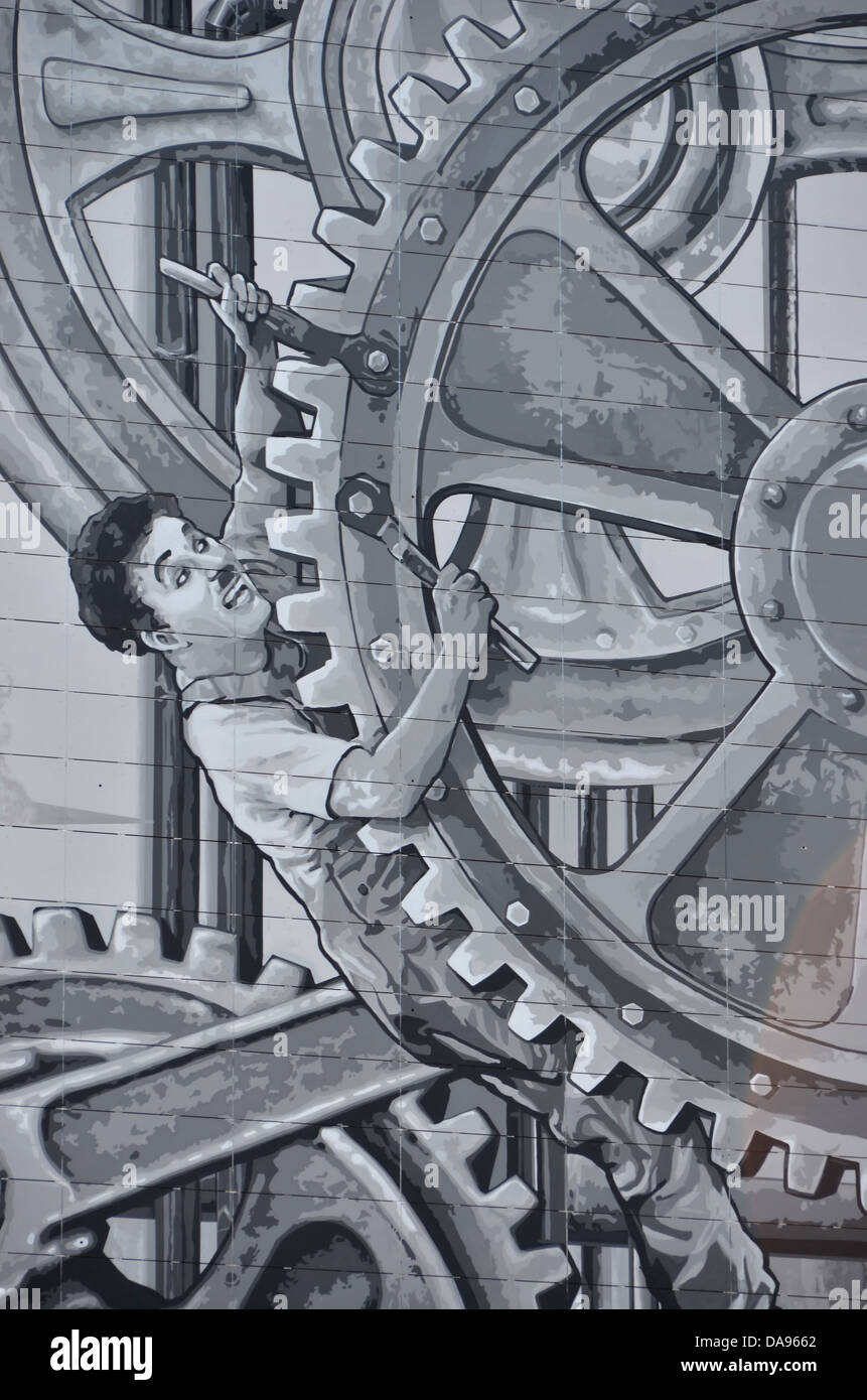 large wall mural painting of charlie Chaplin as the little tramp in the hit move Modern Times. Stock Photo