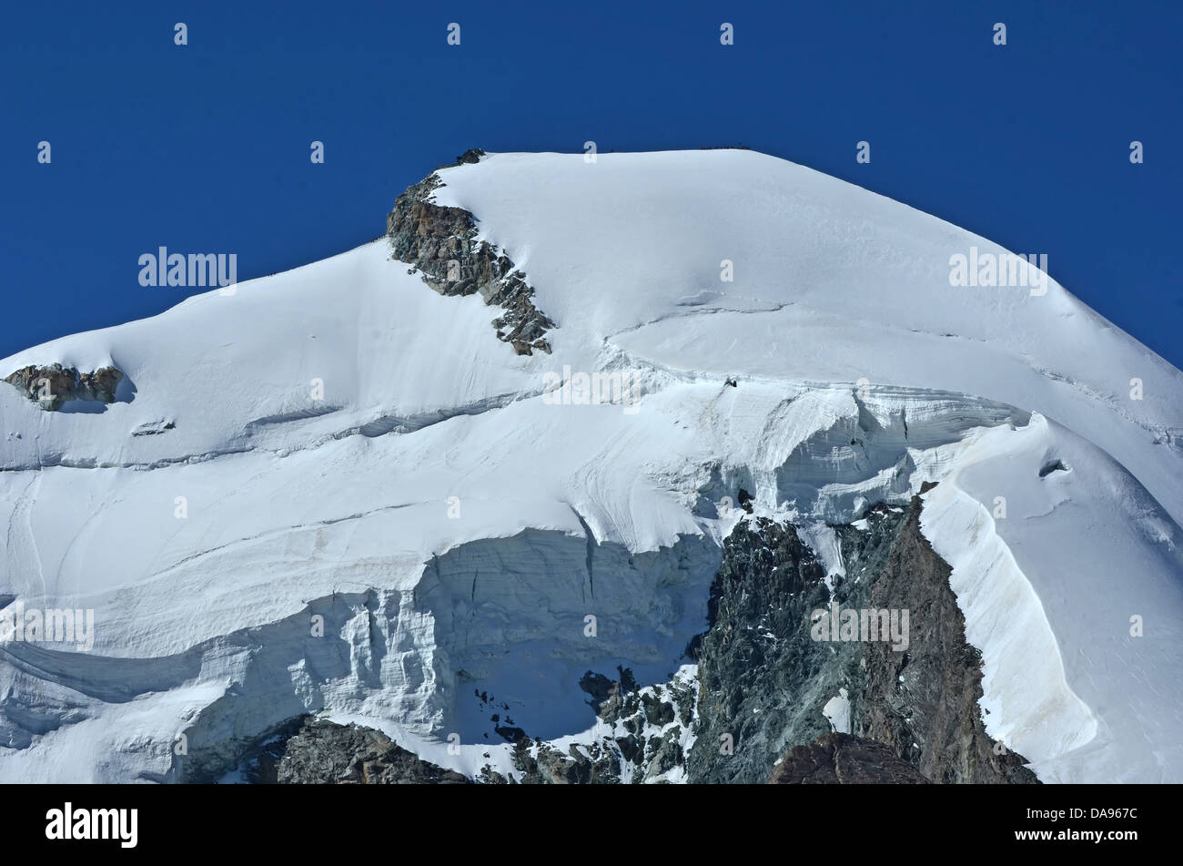 the summit and north face of the Allalinhorn in the southern swiss alps between Zermatt and Saas Fee. Showing a team of, on the Stock Photo