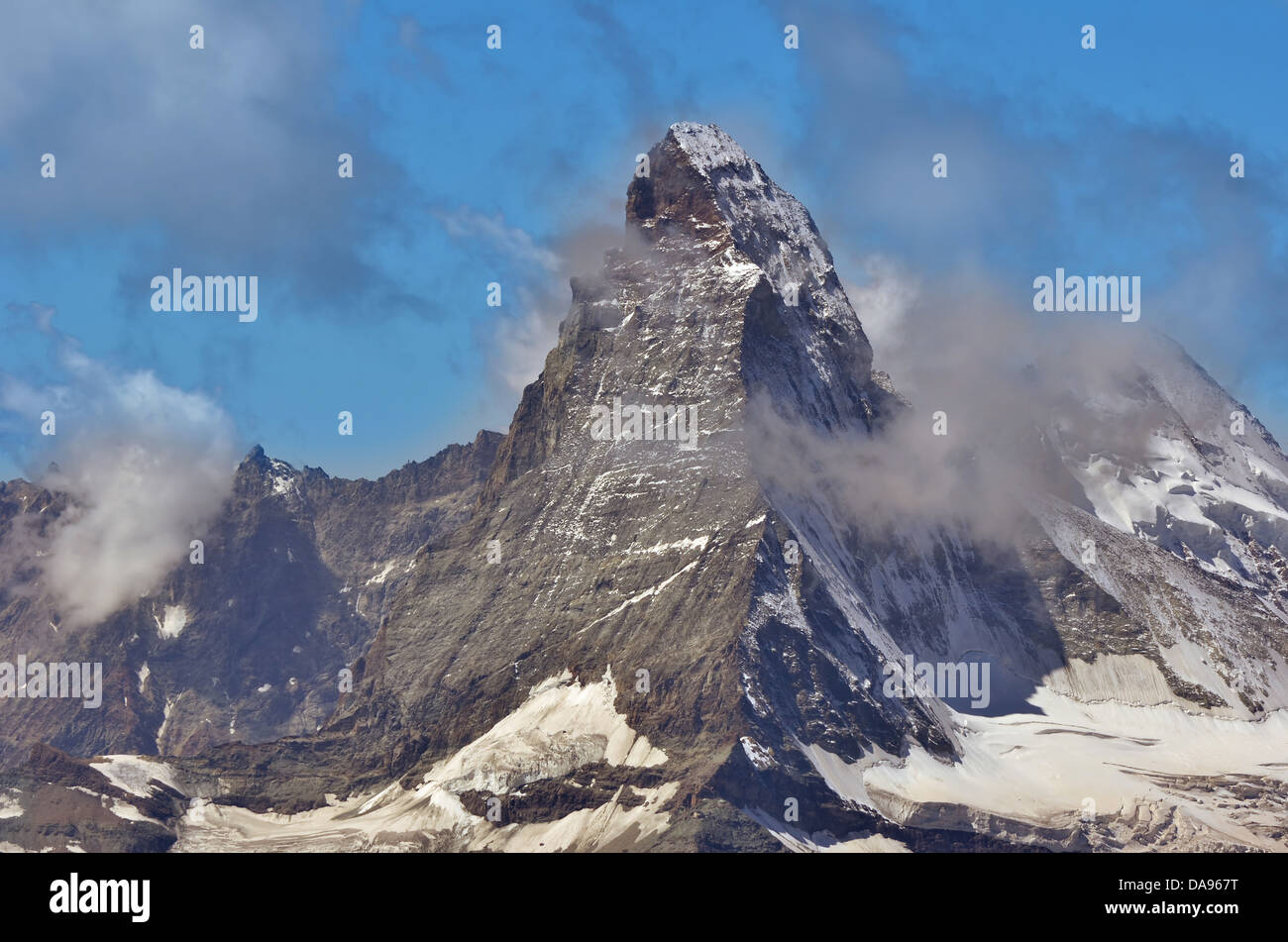 the famous Matterhorn shrouded in whisps of clouds in the southern swiss alps above Zermatt Stock Photo