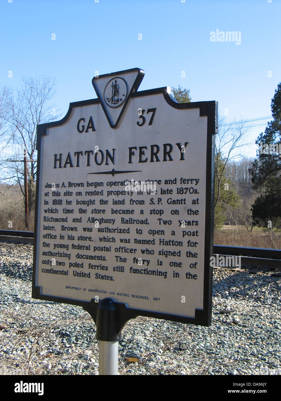 HATTON FERRY James A. Brown began operating a store and ferry at this site on rented property in the late 1870s. In 1881 he bought the land from S. P. Gantt at which time the store became a stop on the Richmond and Alleghany Railroad. Two years later. Brown was authorized to open a post office in his store, which was named Hatton for the young federal postal officer who signed the authorizing documents. The ferry is one of the only two poled ferries still functioning in the continental United States. Department of Conservation and Historic Resources, 1987. Stock Photo