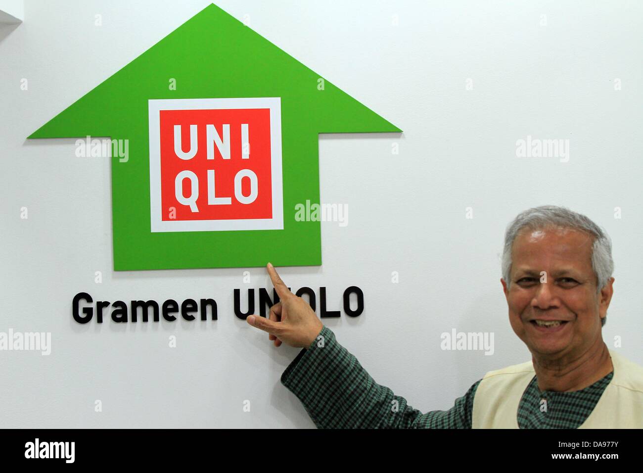 Dhaka, Bangladesh.  8th July, 2013. Nobel Laureate Dr Muhammad Yunus posed with some new dress Grameen UNIQLO stall at at Elephant Road in the city Dhaka. Grameen UNIQLO's objective is to address issues related to poverty, public sanitation, education, gender issues and the environment, by establishing a sustainable, community-level business cycle. Local involvement in the design, production and sale of clothing provides jobs, while helping to develop the economy and improve the quality of life in the country. Stock Photo