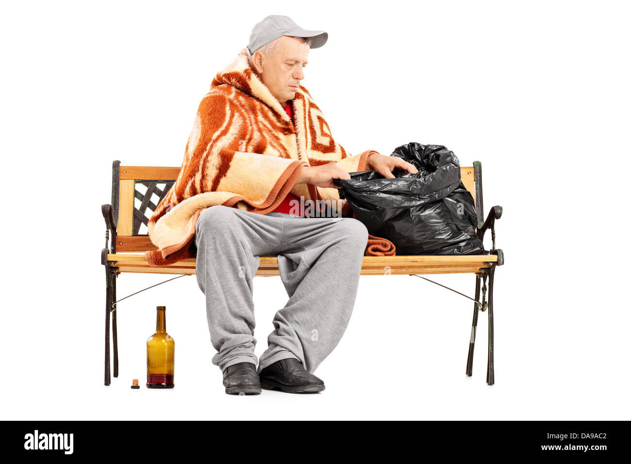 Homeless Mature Man Sitting On A Bench And Looking For Something