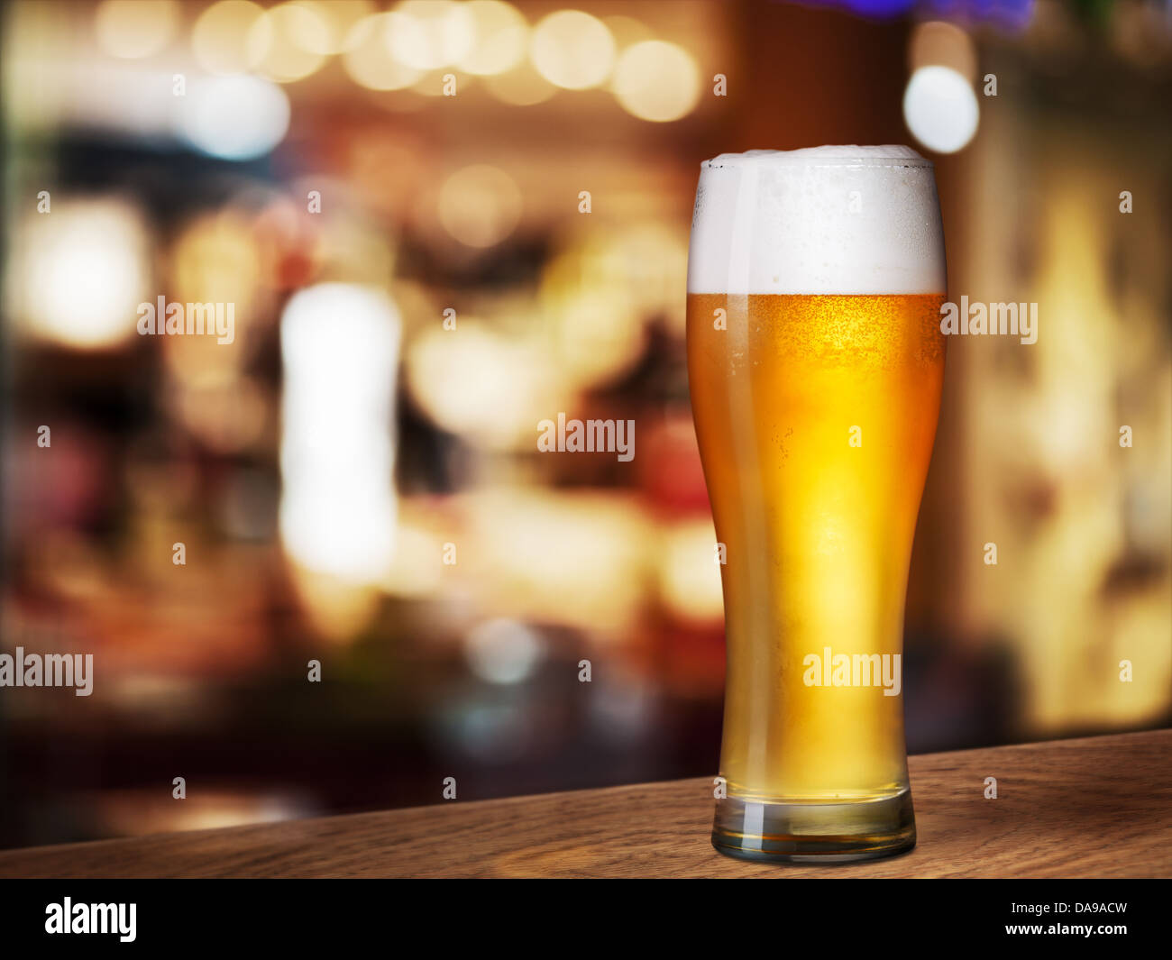 cold beer glass on bar or pub desk Stock Photo