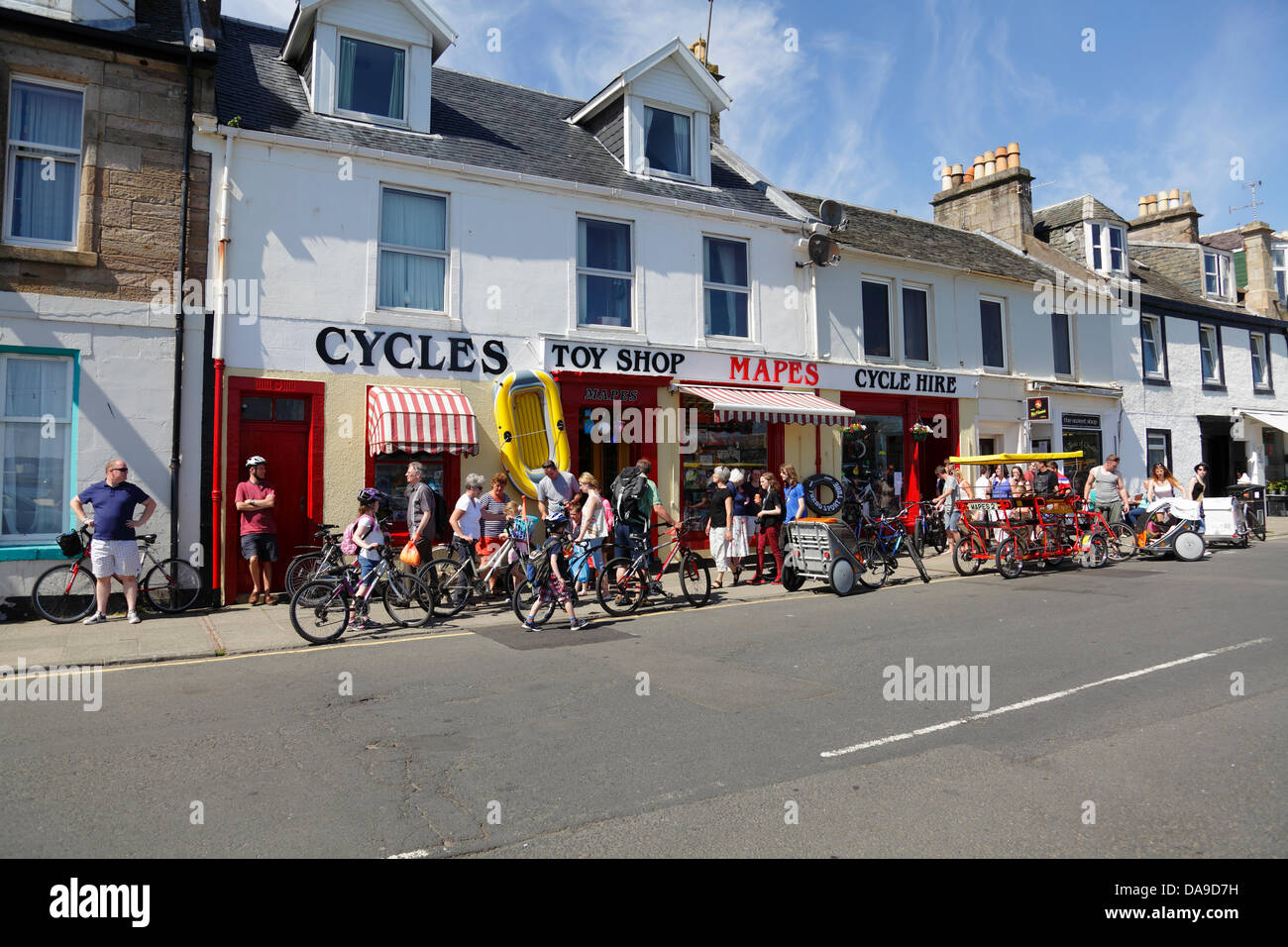Millport, North Ayrshire, Scotland, UK, Monday, 8th July, 2013. Visitors in warm sunshine at Mapes Cycle Hire Shop in the town of Millport on the island of Great Cumbrae in the Firth of Clyde Stock Photo