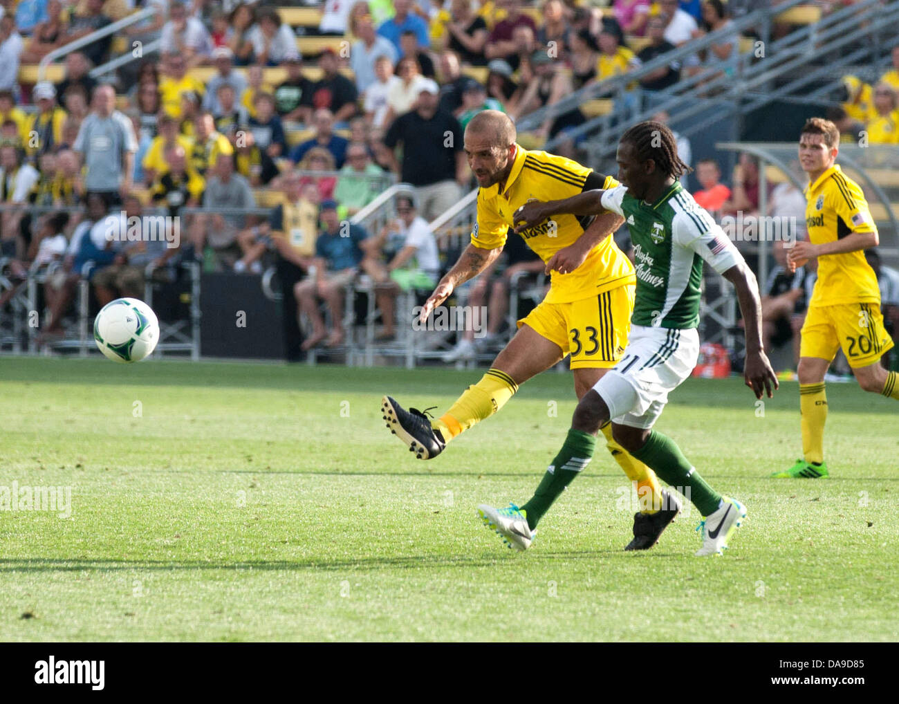 Columbus, OH, USA. 7th July, 2013. July 07, 2013: Columbus Crew Federico Higuain (33) makes a pass by defending Portland Timbers Diego Chara (21) during the Major League Soccer match between the Portland Timbers and the Columbus Crew at Columbus Crew Stadium in Columbus, OH. The Columbus Crew defeated the Portland Timbers 1-0. Credit:  csm/Alamy Live News Stock Photo