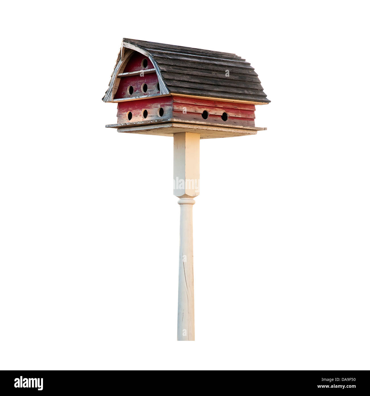 Purple Martin birdhouse made to look like a barn with a Gambrel roof. Isolated on white with a clipping path. Stock Photo