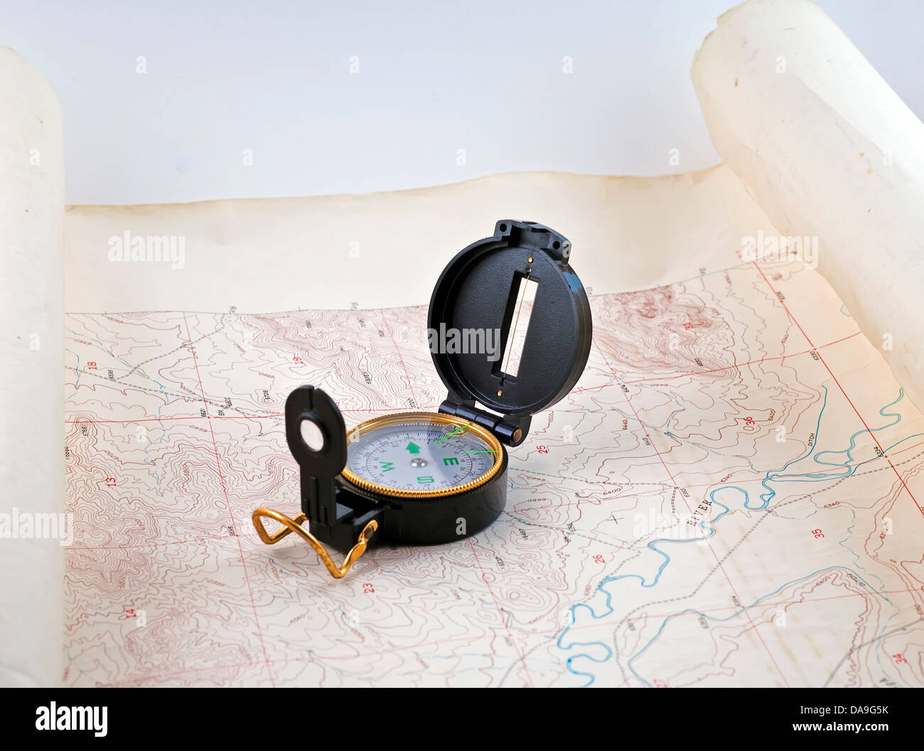 compass laid out over a topographical map Stock Photo