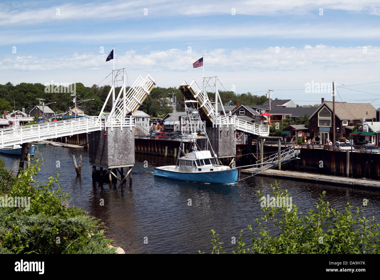 Boats passing under the open drawbridge at Perkins Cove, Ogunquit, Maine, USA. Oginquit is a popular New England vacation destination Stock Photo