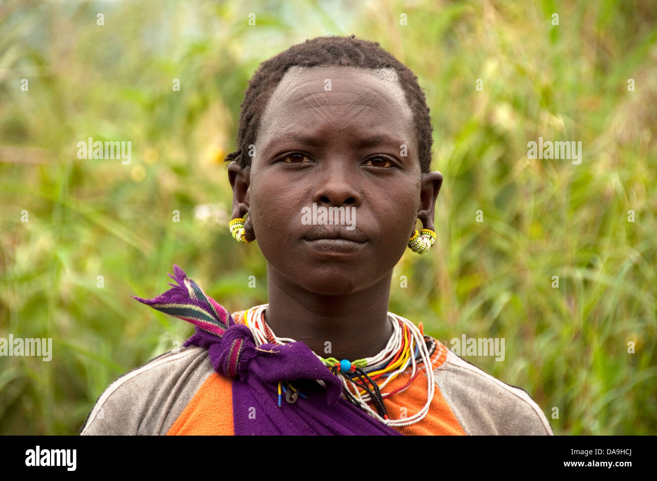Kachipo girl with earrings, necklaces and scarifications on the forehead, Ethiopia Stock Photo